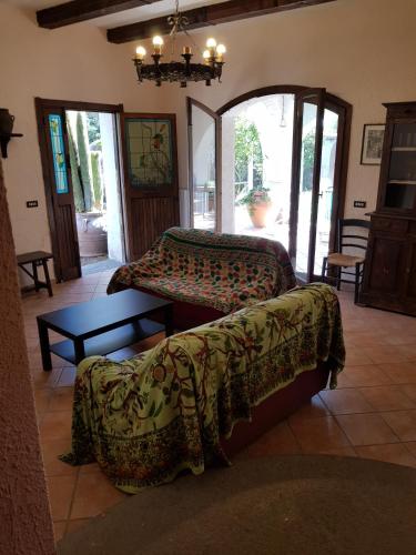 a living room with two beds and a table at La Limonaia in Castel Volturno
