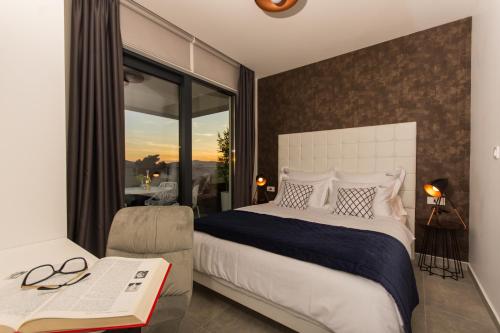 a bedroom with a large bed and a window at Villa Royal in Trogir