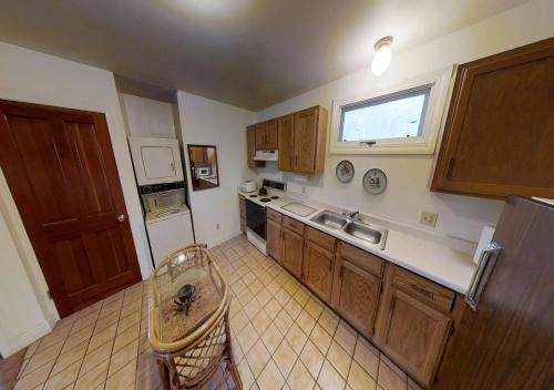 a kitchen with wooden cabinets and a counter top at Dodgeton Creek Inn in Cuchara