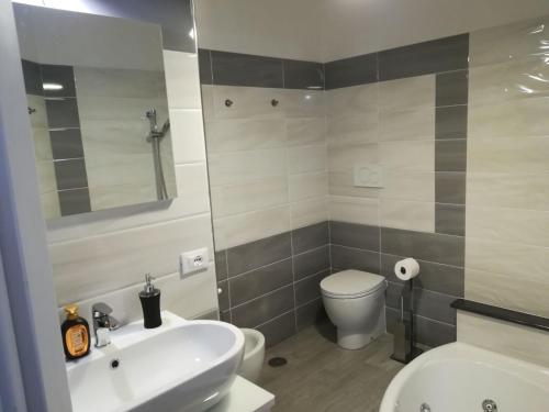 a bathroom with a white sink and a toilet at Sosta Rock in Casal Palocco