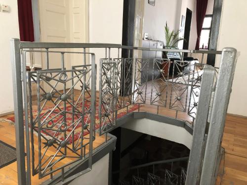 a wine tasting room with a black iron railing at Mosaico Alfetta Hostel in Timişoara