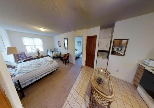 a bedroom with a bed and a living room at Dodgeton Creek Inn in Cuchara