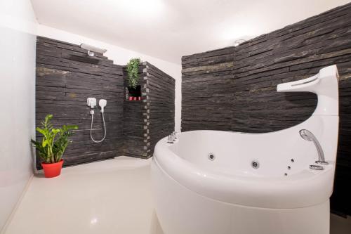 a bathroom with a white tub and a sink at Halna Residence in Krynica Zdrój