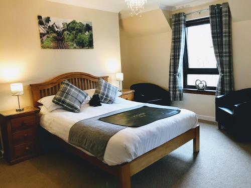 a bedroom with a large bed and a window at Ben Nevis Guest House in Fort William