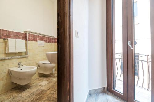 a bathroom with two toilets and a sink at Karama in Dorgali