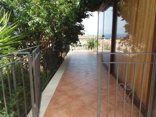 a walkway leading to the balcony of a house at Villa in vetro in Castellammare del Golfo