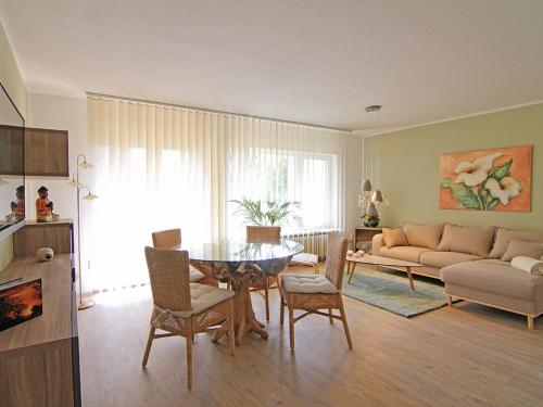 a living room with a table and a couch at Balance Revital-Hotel in Badenweiler