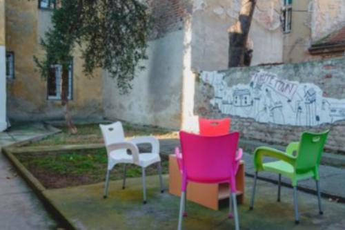 a group of chairs sitting in front of a building at Hostel White Town in Belgrade