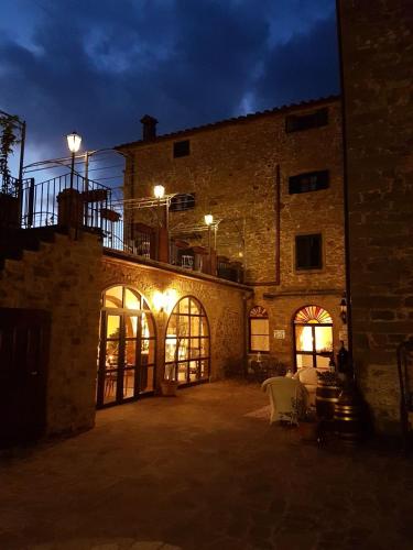 a large brick building with a courtyard at night at Villa Schiatti in Cortona