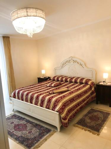 a bedroom with a bed and two night stands at Atticus Apartment in Giardini Naxos