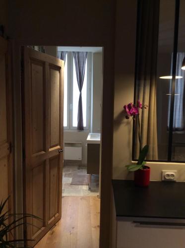 an open door to a bathroom with a window at T2 centre ville avec extérieur in Avignon