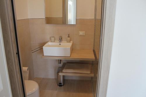 a bathroom with a sink and a toilet at Piccolo Ulivo B&B Salento in Vernole