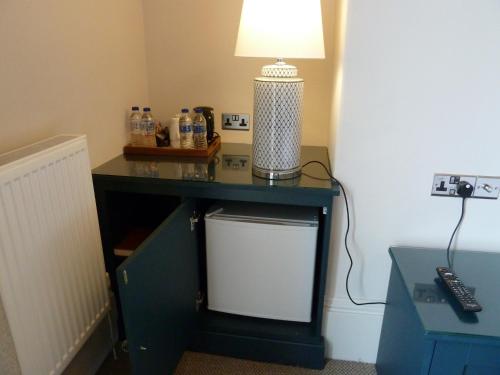 a blue desk with a lamp on top of it at Edgar Townhouse in Bath