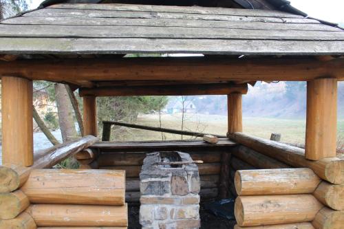 a wooden building with a pile of logs at Садиба Верховинський водограй in Synevyrsʼka Polyana