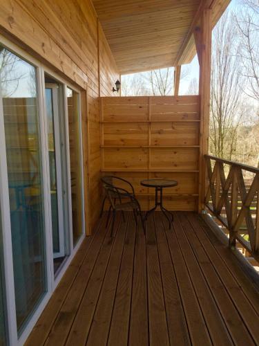 a screened in porch with a table and chairs on it at Relax villa Poduzska in Sinyak