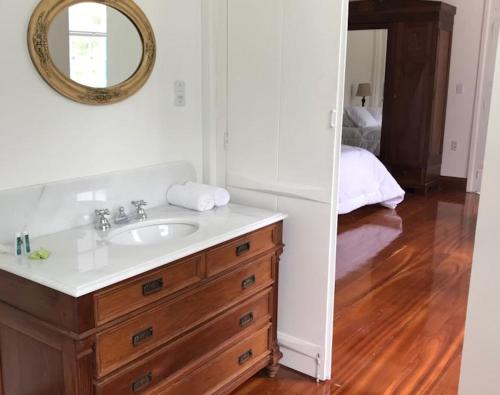 a bathroom with a sink and a mirror at Charqueada Santa Rita Pousada de Charme in Pelotas