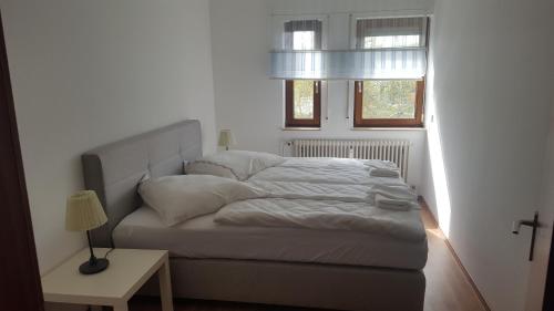 a bed in a small room with a window at City Home 1 in Metzingen