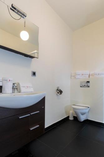 a bathroom with a sink and a toilet at The Queen Luxury Apartments - Villa Carlotta in Luxembourg