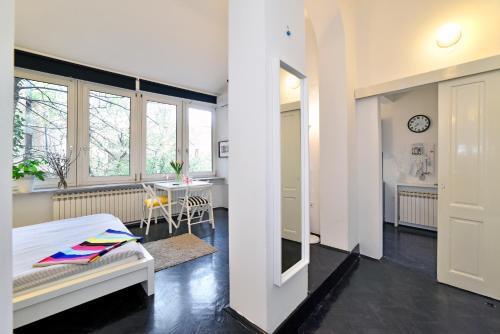 a bedroom with a bed and a room with a table at Zagreb Center Apartments in Zagreb