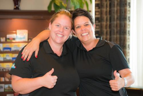 two women standing next to each other giving thumbs up at Days Inn by Wyndham Berthierville in Berthierville