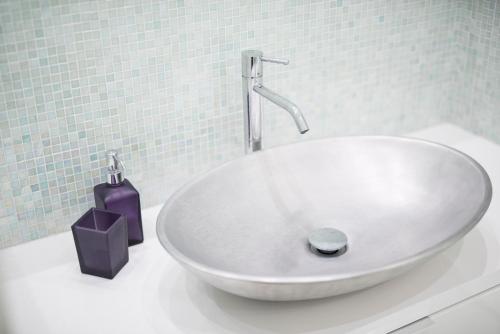 a white sink with a faucet on a counter at 330 Holiday Apartments Manarola in Manarola