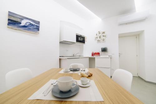 a kitchen and dining room with a wooden table and chairs at 330 Holiday Apartments Manarola in Manarola