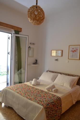 a bedroom with a large bed and a chandelier at Asimelia Luxury Apartment in Heraklio