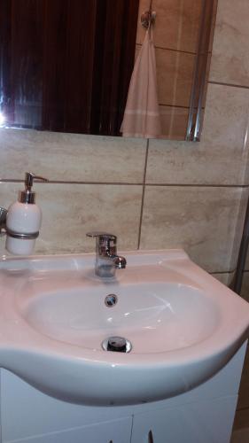 a white sink in a bathroom with a mirror at Zajazd Wiejski in Ozorzyce