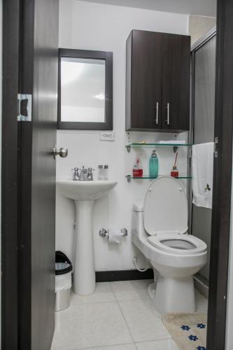 a bathroom with a toilet and a sink at construcciones Guaduales del café in Montenegro