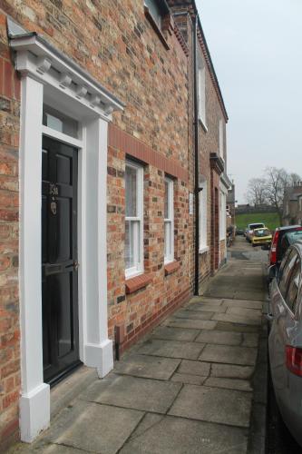 a brick building with a door on the side of it at Kyme Street, central York in York