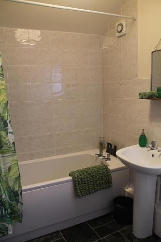 a bathroom with a sink and a bath tub and a sink at Kyme Street, central York in York