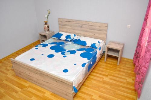 a bedroom with a bed and a table and a chair at Sofia Guest House in Kutaisi