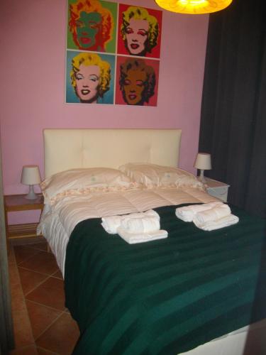 a bedroom with a bed with two towels on it at La Corte del Frate in Panzano
