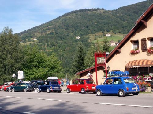 a group of cars parked on the side of a street at Auberge Alsacienne in Bussang