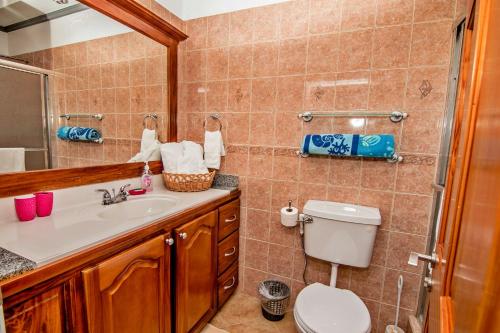 a bathroom with a toilet and a sink at Paradise Cove in Gros Islet
