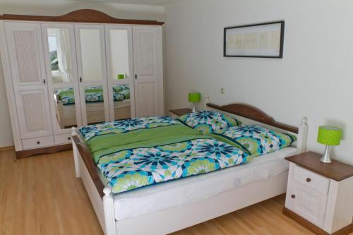 a bedroom with a large bed with a white frame at Bernkasteler Moselpanorama in Bernkastel-Kues