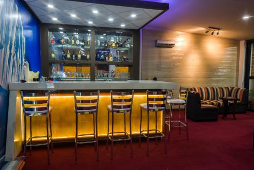 a bar in a restaurant with stools at Hotel El Rubi in Huaraz