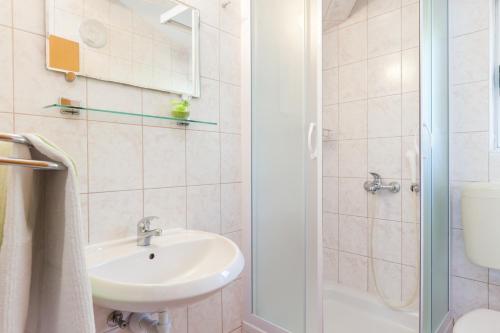 a bathroom with a sink and a toilet and a shower at Vila Nela in Tučepi