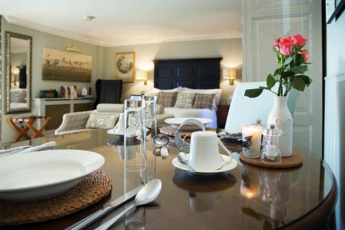 a living room with a table with a vase of flowers on it at Luxury Escape in Hunstanton
