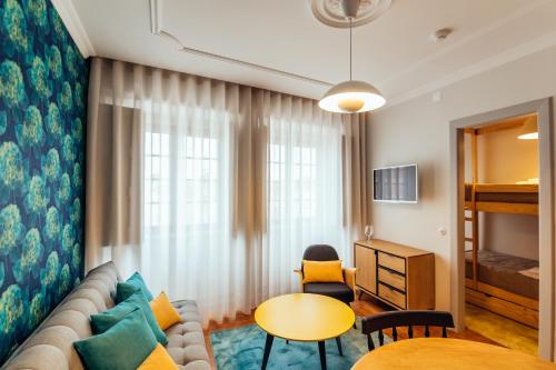 a living room with a couch and a table and a bed at Bordallo's Prime Apartments in Caldas da Rainha