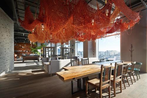 a room with a table and chairs in it at L7 Hongdae by LOTTE in Seoul