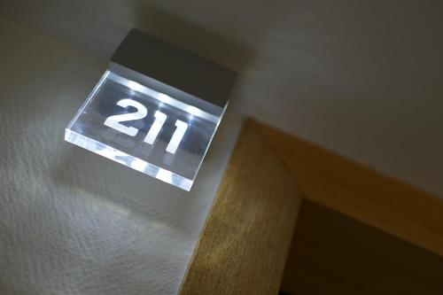 an elevator sign with the number on it at Nex Hôtel in Tarbes