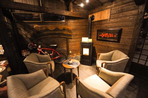 a restaurant with a bike in a room with chairs at Yamashinobu in Minamioguni