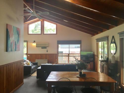 a living room with a couch and a table at Holiday Heights in Halls Gap