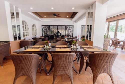 a dining room with tables and chairs at Grandvrio Resort Saipan in Garapan