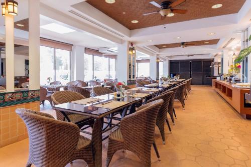a dining room with tables and chairs in a restaurant at Grandvrio Resort Saipan in Garapan