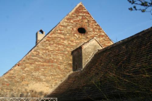 a brick building with a window on top of it at Chalupa u kostela in Lukov