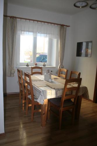 a dining room with a table and chairs and a window at Chalupa u kostela in Lukov