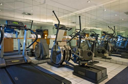 a gym with a bunch of exercise bikes in it at Wyndham Hannover Atrium in Hannover