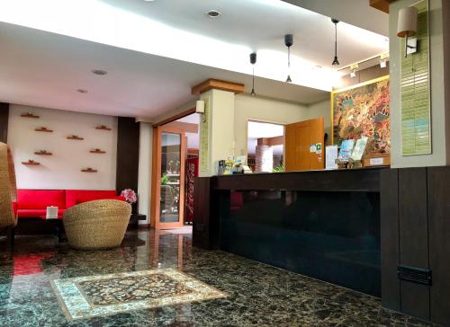 a lobby with a bar and a red couch at Hua Hin White Sand in Hua Hin